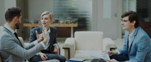 three people in a meeting
