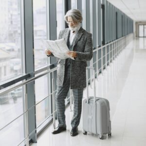 man with suitcase looking at a map