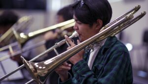 students playing the trombone during rehearsal