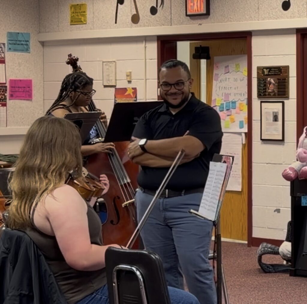 orchestra director with violin student
