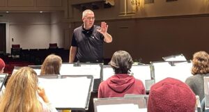 Dr. Andrew Smouse conducting during a rehearsal at a clinic