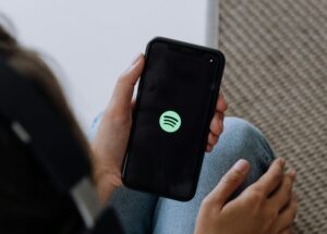 closeup of phone with Spotify logo on screen