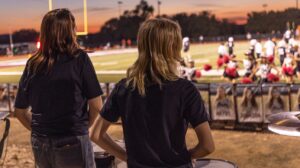 St. Michael's mostly female drumline watching a football game