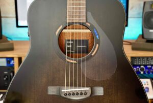 The top of an acoustic guitar showing its sound hole and surrounding rosette.