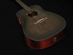 The body of a black acoustic guitar.