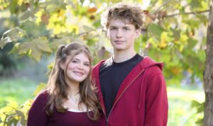 A smiling girl and her teenage brother.