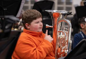 student holding euphonium