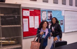 two happy students walking in band room