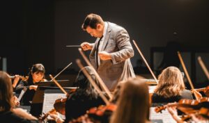 music conductor in front of orchestra