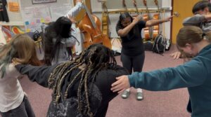 orchestra students demonstrating unique hand shake