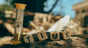 small hourglass with block letters that spell out "time"