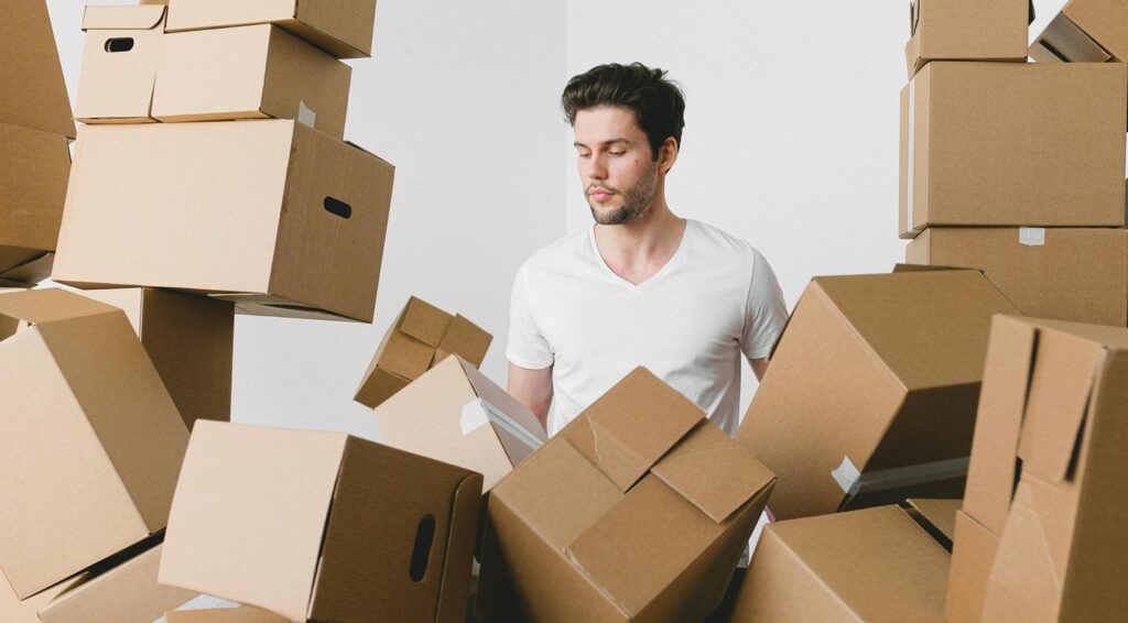 man in the middle of moving boxes