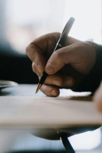 close up of hand writing notes