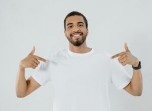 man using both hands to point at himself