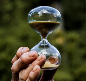 hand holding small hourglass