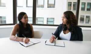 meeting of two women sitting at table