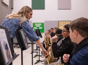 educator helping saxophone section