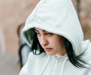 upset teen wearing hoodie