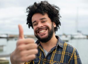 smiling man with a thumbs up