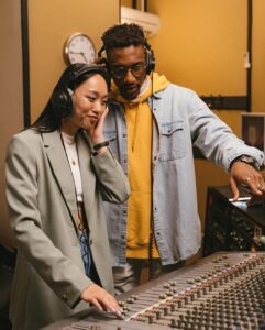 two people with headphones using sound equipment