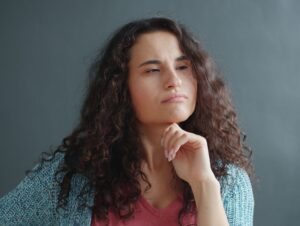 woman thinking with fist under her chin