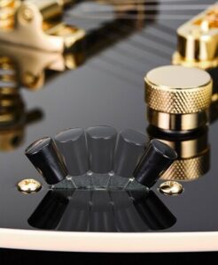 The five positions of a pickup selector switch on a black electric guitar.