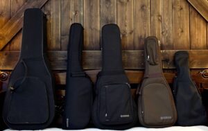The Yamaha AC5R, SLG220N, CSF3M, JR2S and GL1 acoustic guitars in their cases and gig bags.