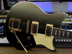 Closeup of the front body of a black electric guitar.