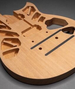 The interior of an electric guitar body showing chambers in the wood.