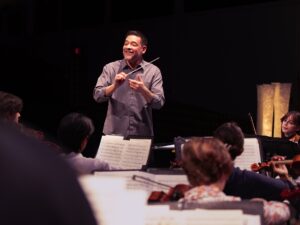 music educator conducting during rehearsal