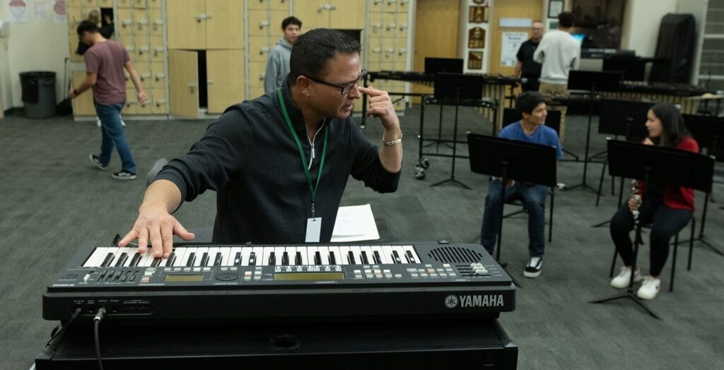 music educator in band room with Yamaha Harmony Director