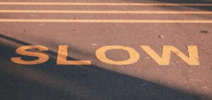 the word "slow" painted on the ground