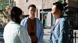 three colleagues talking outside