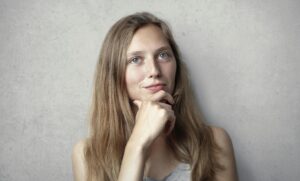 woman thinking with hand holding chin